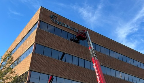 Infoscitex Dayton Office Sign being hung onto the building photo